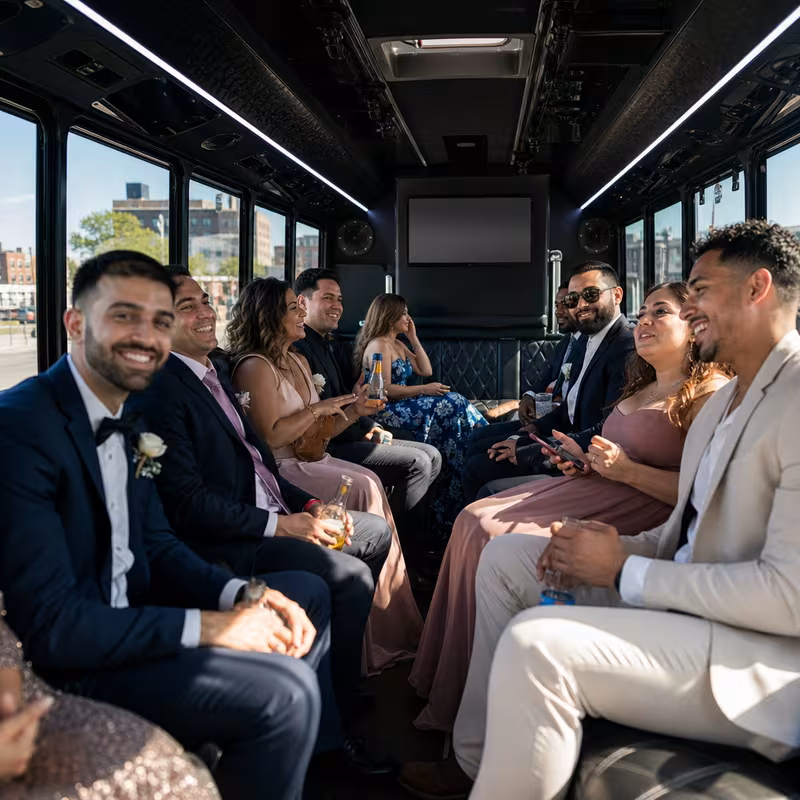 Wedding guests seated inside a Newark party bus