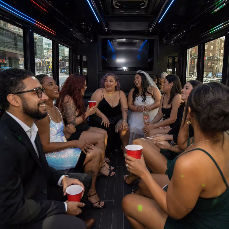 Party bus interior with wraparound leather seating and LED lighting in Newark