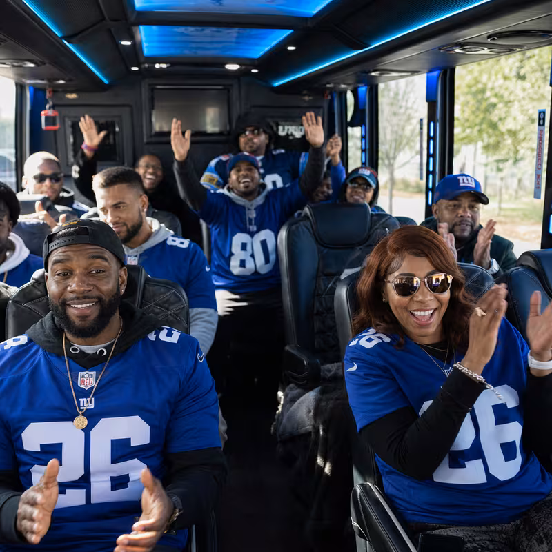 Group boarding a white charter bus for Sporting Event Transportation transportation in Newark